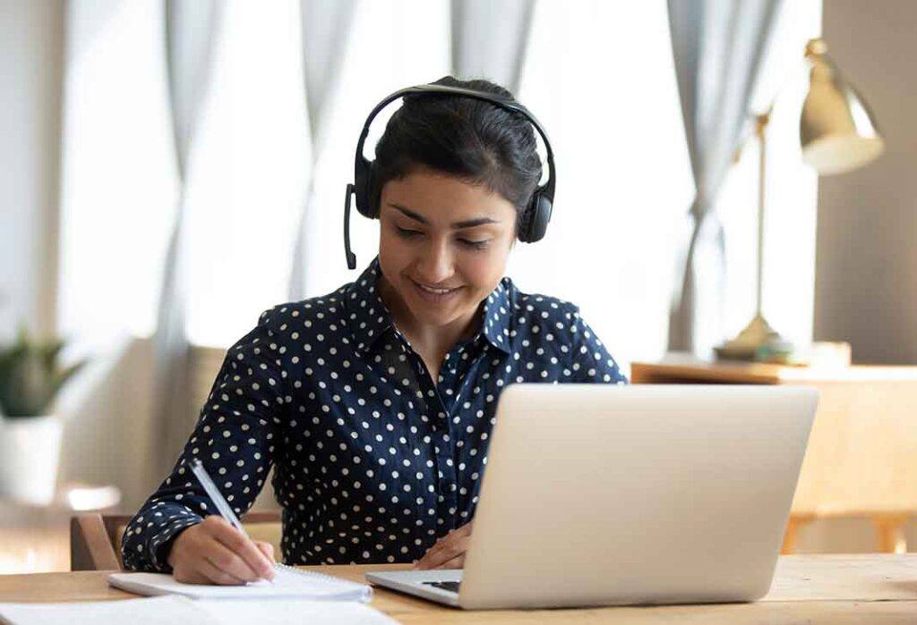 Woman with headset at laptop